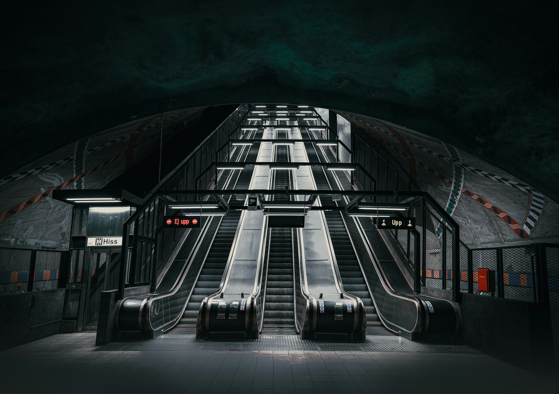 an escalator in a subway station at night